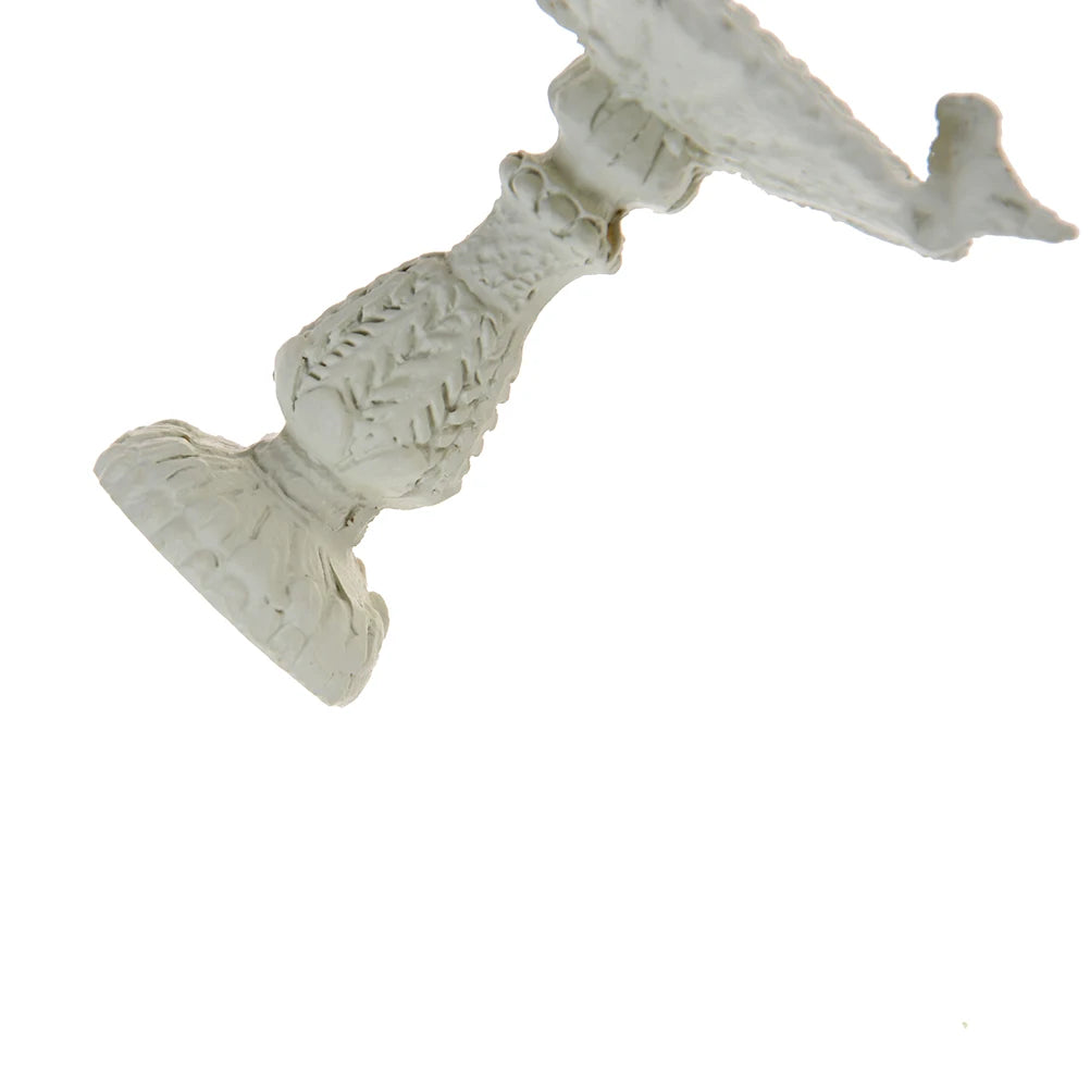 Ornate white ceramic pedestal stand with intricate textured design, featuring a shallow bowl on top. The object is photographed against a plain white background.