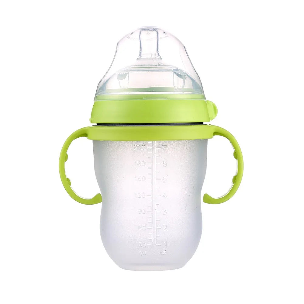 Translucent baby cup with green handles and lid, featuring measurements on the side. The lid has a clear silicone spout, designed for easy gripping and drinking.