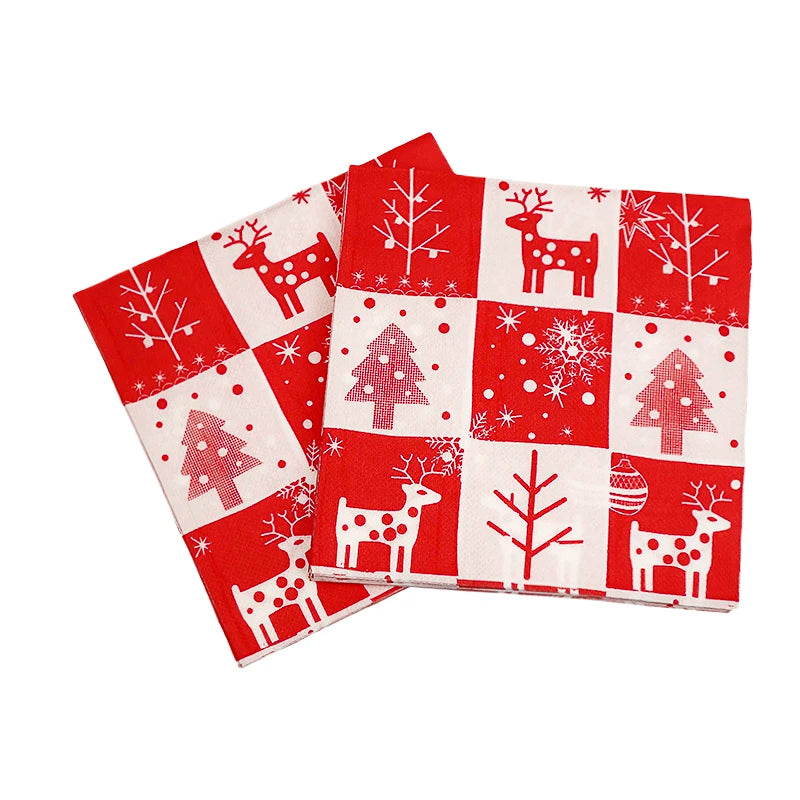 Red and white Christmas-themed napkins with reindeer, trees, snowflakes, and ornaments in a checkered pattern.