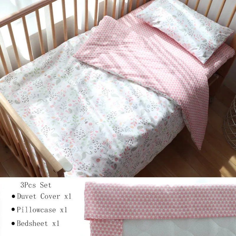 A crib with floral-patterned bedding set, including a pastel pink and white duvet cover, pillowcase, and bedsheet. Sunlight softly illuminates the wooden crib.