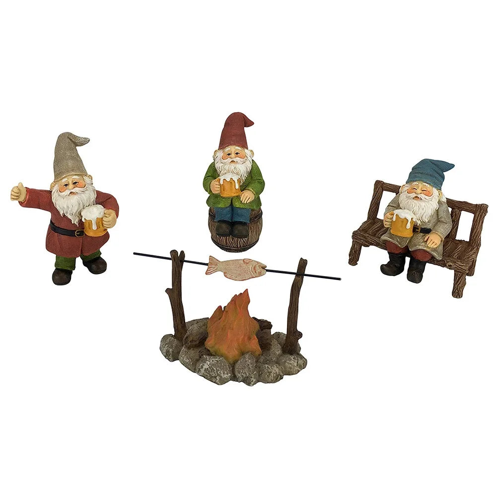 Three garden gnome figures with mugs surround a small campfire with a fish on a skewer. One gnome sits on a barrel, another on a bench, and the third stands raising a mug.