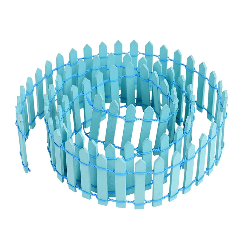 A coiled miniature blue wooden picket fence, held together by matching wire, with evenly spaced vertical slats.