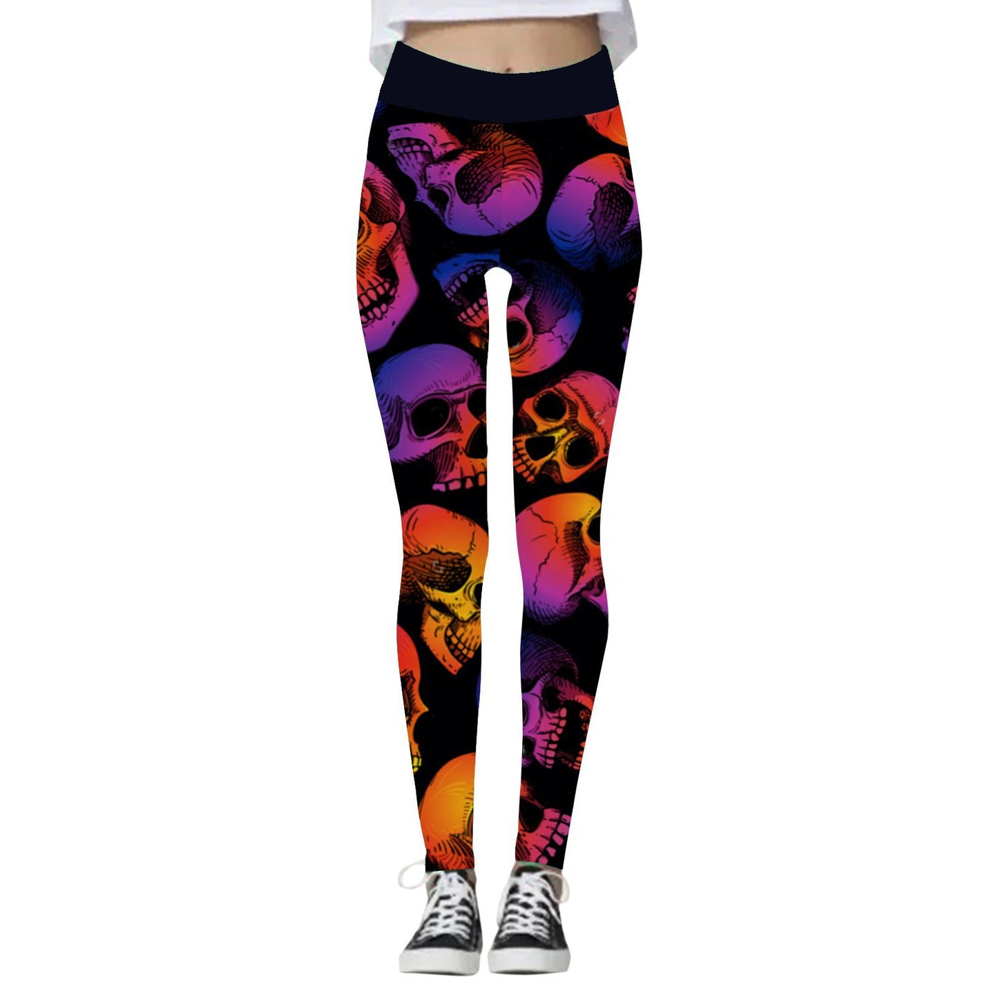 Leggings with colorful skull patterns in shades of orange, pink, and purple on a black background. Paired with black and white sneakers, cropped at the waist.