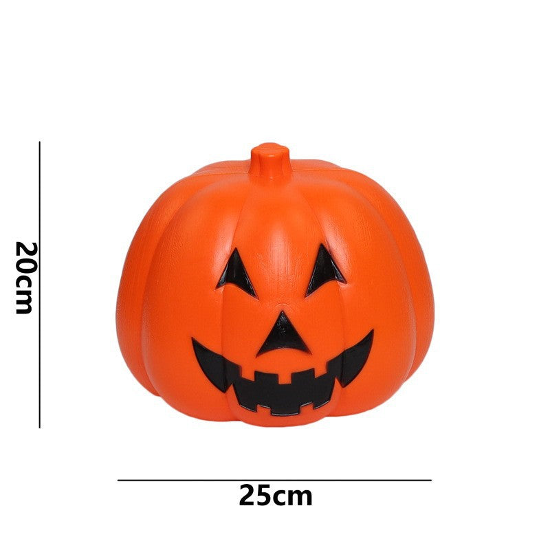 Orange plastic pumpkin with a black carved face, featuring a triangular nose and eyes and a jagged grin. Dimensions shown are 20cm tall and 25cm wide.