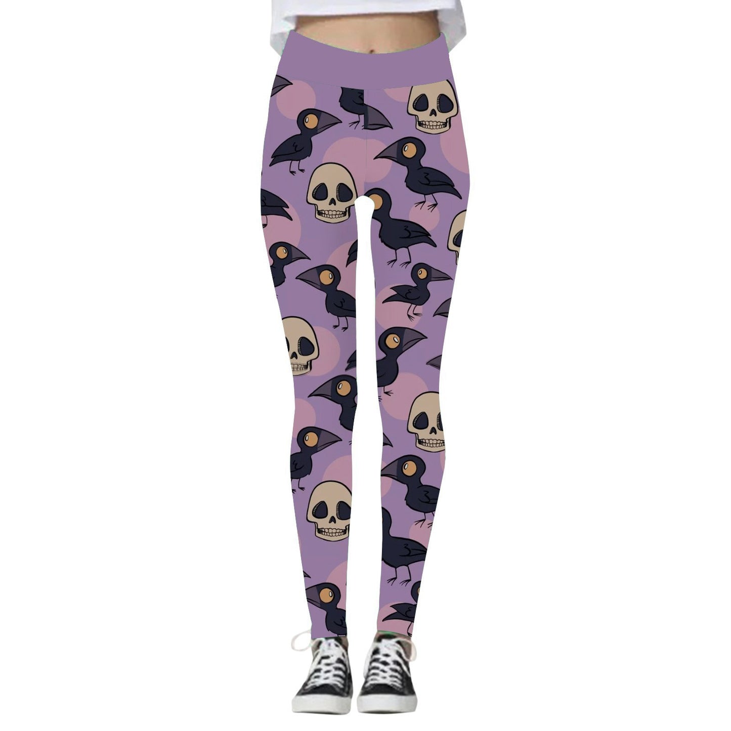 Purple leggings with a pattern of black crows and beige skulls. The wearer is standing, wearing black and white sneakers, with a white top partially visible.