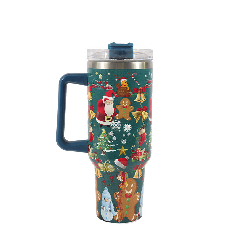 Festive travel mug with Christmas-themed graphics including Santa, gingerbread men, and snowflakes on a teal background. Features a blue handle and a clear lid.