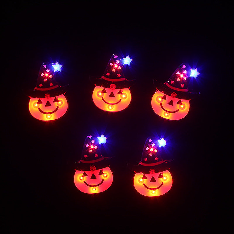 Five glowing pumpkin faces with triangular eyes and smiles, wearing star-patterned wizard hats. Each hat is topped with a blue star, glowing against a black background.