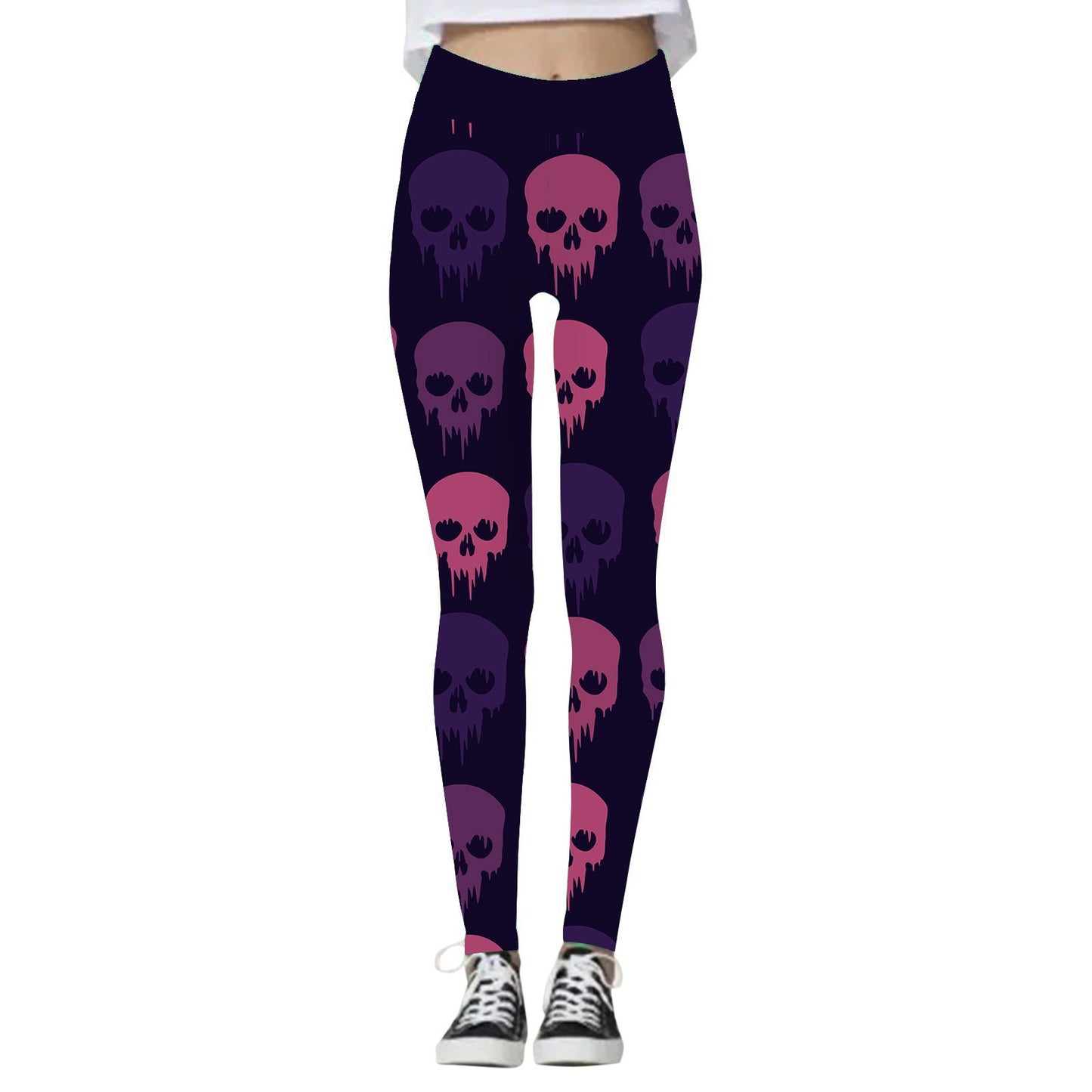 Women's leggings featuring a dark background with a pattern of purple and pink dripping skulls, paired with black sneakers and a cropped white top.