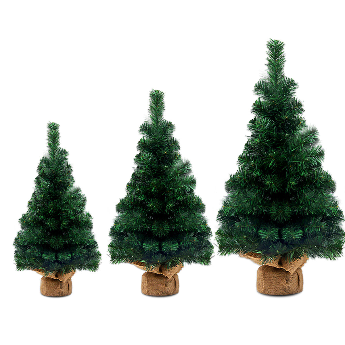 Three artificial Christmas trees in varying sizes stand side by side on a white background. Each tree is lush and vibrant, supported by a burlap-wrapped base.