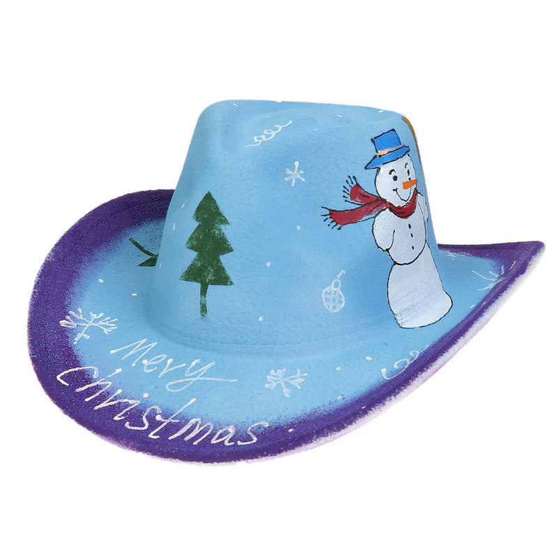 A blue and purple cowboy hat with festive decorations, including a snowman, pine tree, snowflakes, and "Merry Christmas" handwritten on the brim.