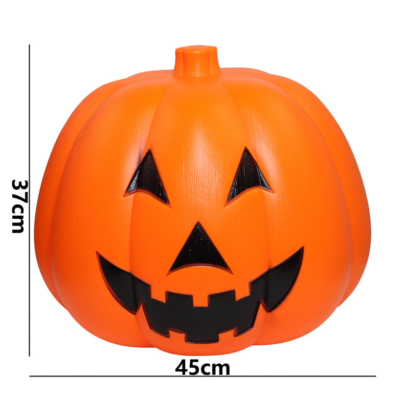 Large plastic jack-o'-lantern decoration with a wide smile and triangular eyes. The height is 37cm and the width is 45cm. The pumpkin is bright orange with black details.