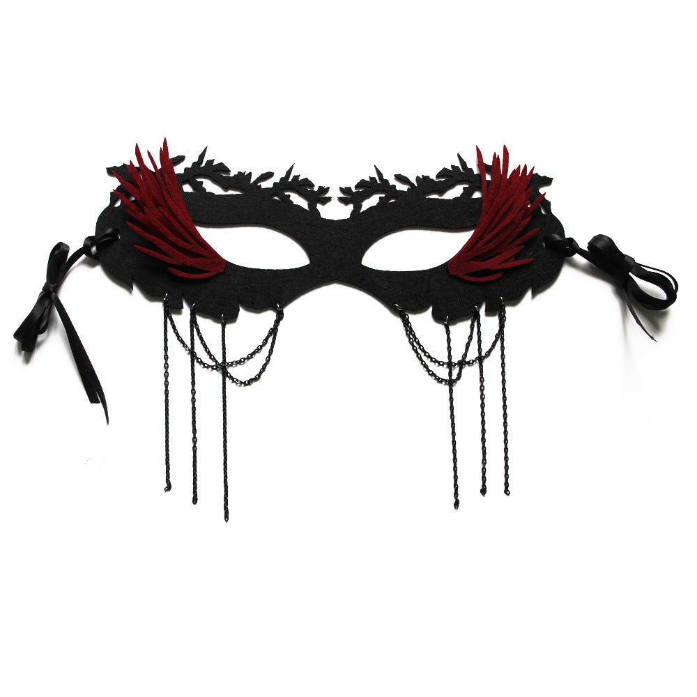 Elegant black masquerade mask with red feather accents and dangling black chains. Features intricate cutouts and black ribbon ties for fastening.