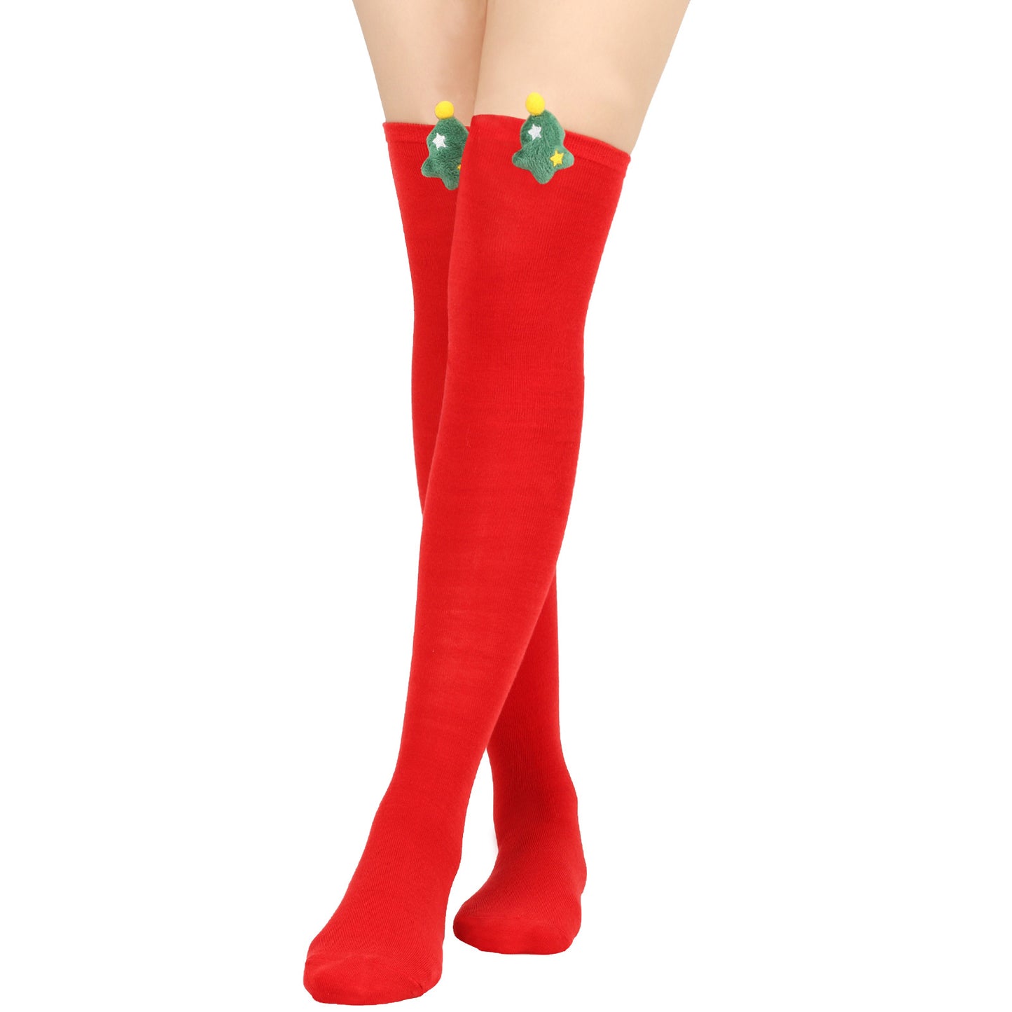 Person wearing red thigh-high socks with green Christmas tree decorations and yellow pom-poms attached near the top against a white background.