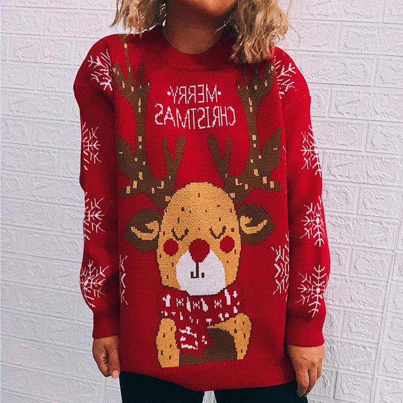 Person wearing a red Christmas sweater featuring a reindeer with antlers and snowflakes on the sleeves. The sweater has the text "MERRY CHRISTMAS" in reverse at the top.