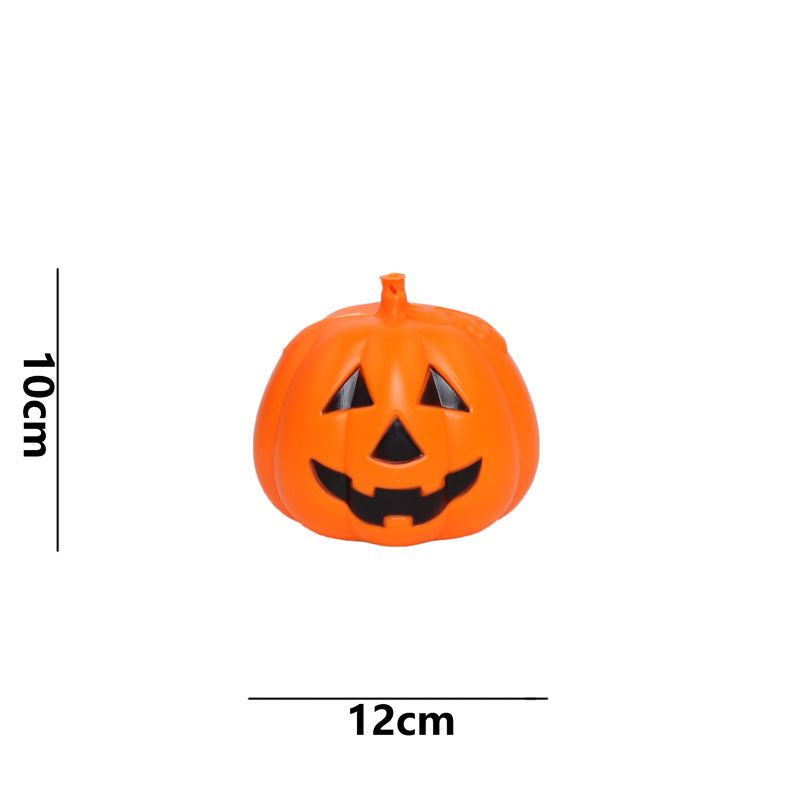 Orange plastic jack-o'-lantern with a smiling face measures 10cm by 12cm, shown against a white background.