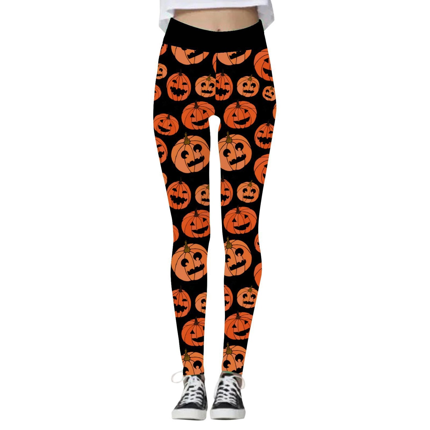 Leggings featuring a repeating pattern of smiling orange jack-o'-lanterns on a black background. The wearer pairs them with black and white sneakers.