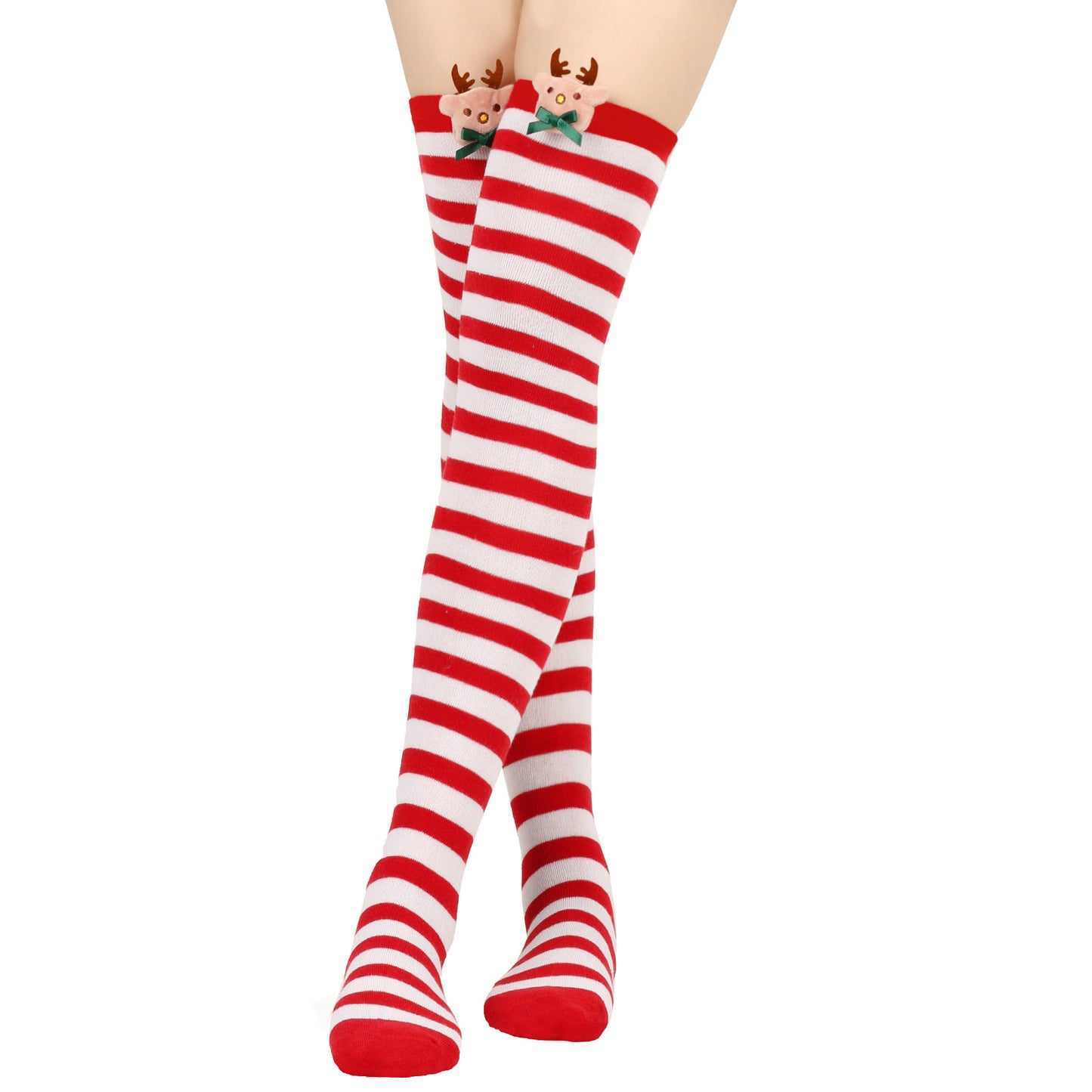 Red and white striped knee-high socks with reindeer faces and green bows near the top, worn on crossed legs against a white background.