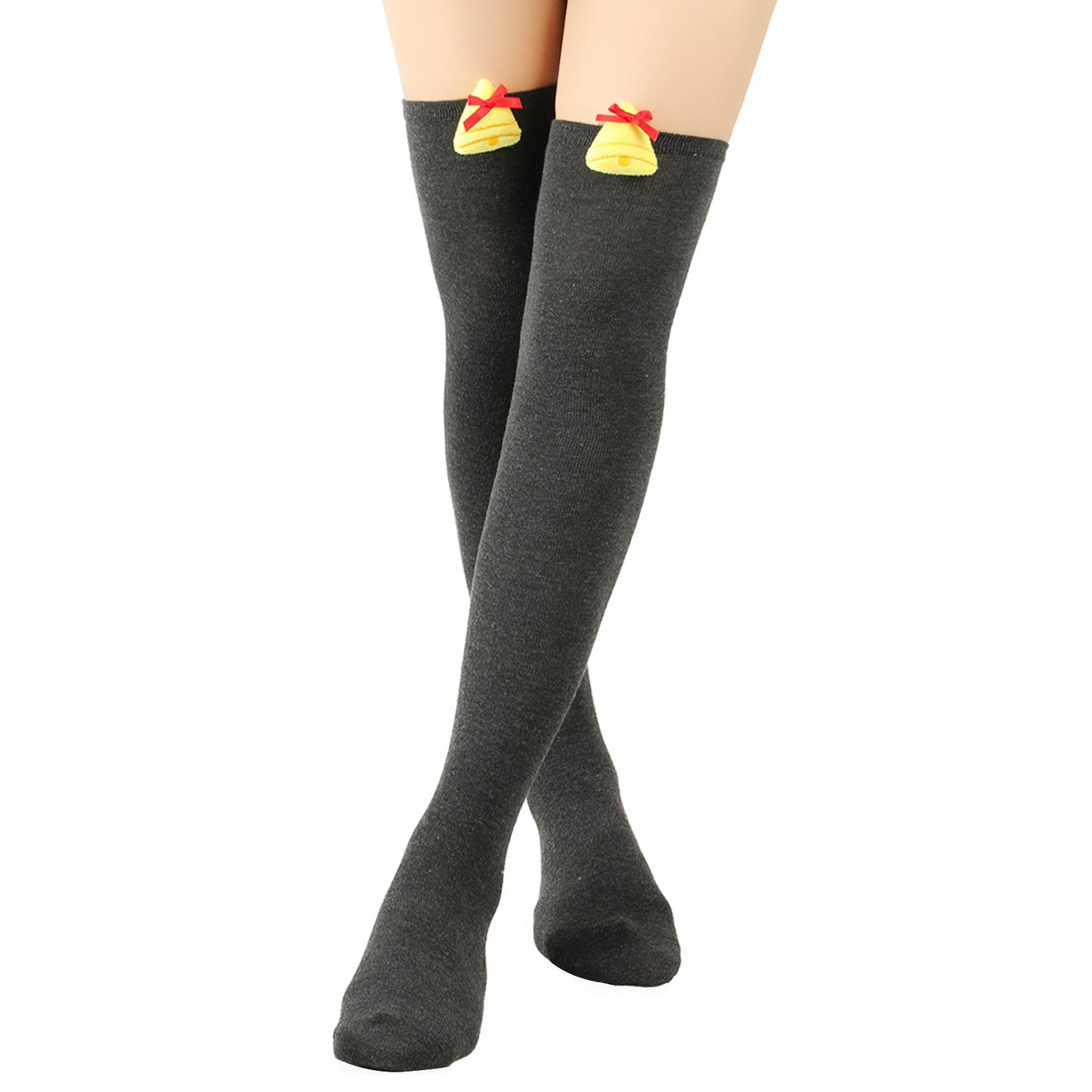 Dark gray thigh-high socks featuring yellow bell decorations with red bows at the top, worn by a person with crossed legs against a white background.
