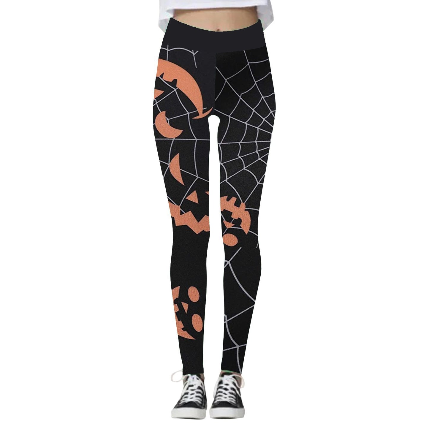 Black leggings with orange jack-o'-lantern and spiderweb designs, worn with black sneakers. The festive Halloween pattern adds a playful touch to the outfit.