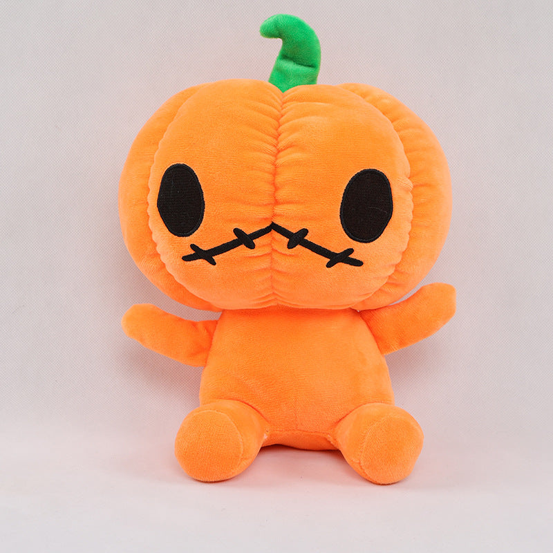 Cute plush toy of an orange pumpkin character with stitched black eyes and mouth, sitting upright. It has a green stem on top, against a neutral background.
