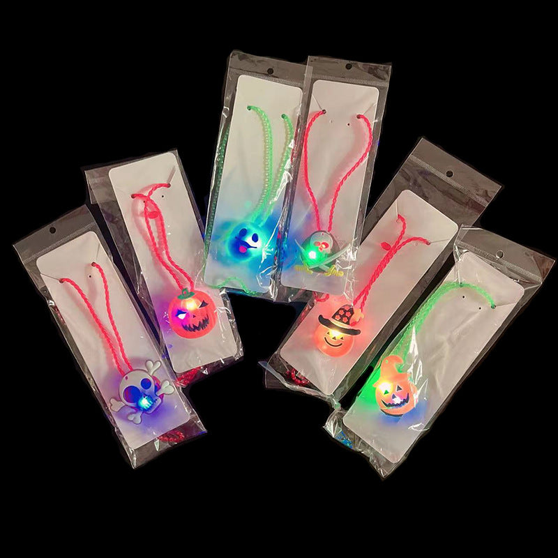 Six packaged Halloween-themed LED necklaces with glowing designs, including pumpkins and skulls, are arranged against a black background.