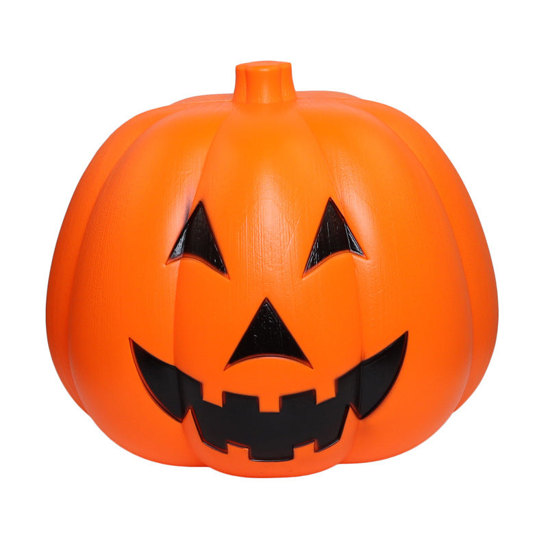 Bright orange plastic jack-o'-lantern with a smiling face, featuring triangular eyes and a jagged mouth. Its surface has a smooth, glossy texture.