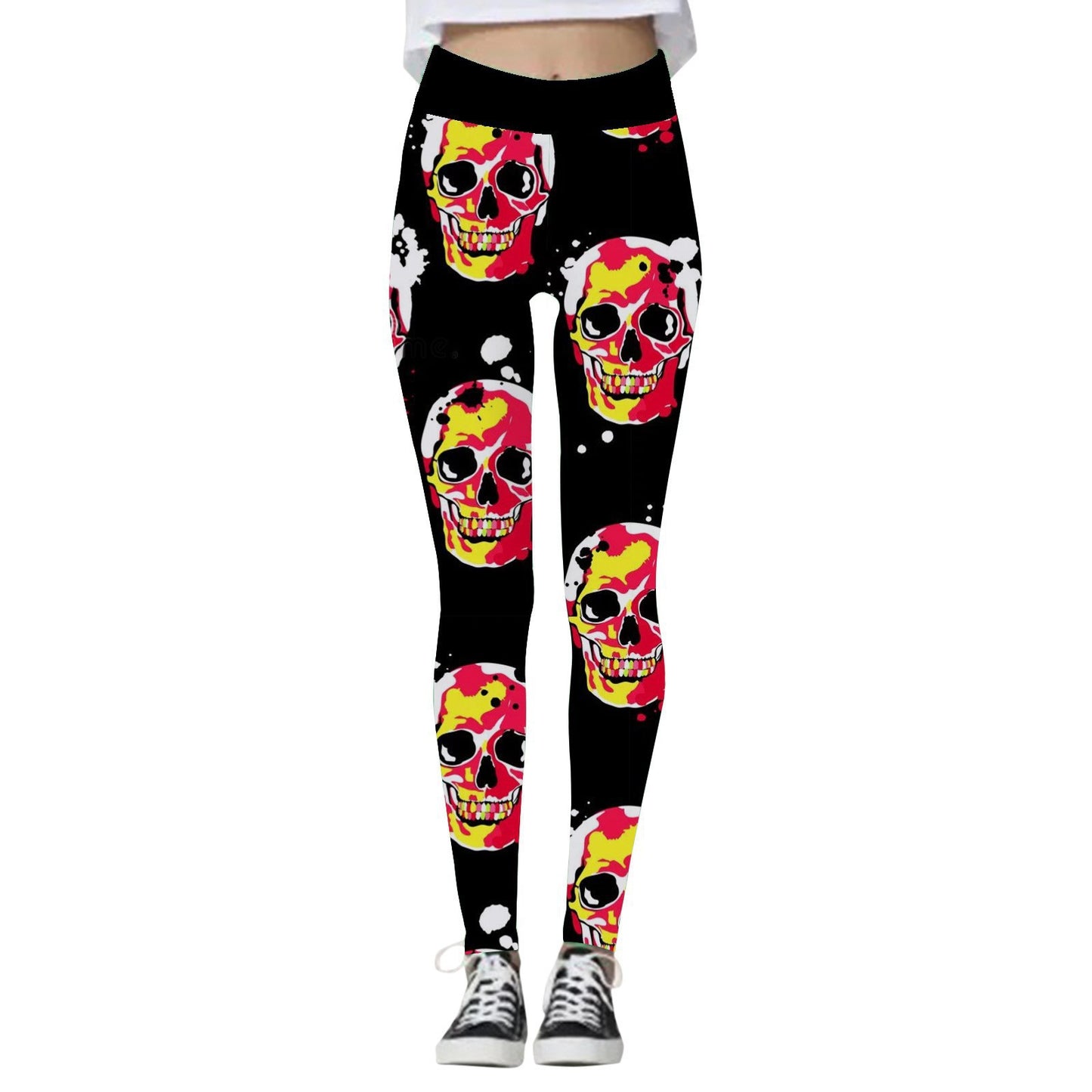 Black leggings featuring a vibrant red and yellow skull pattern, worn with black and white sneakers.