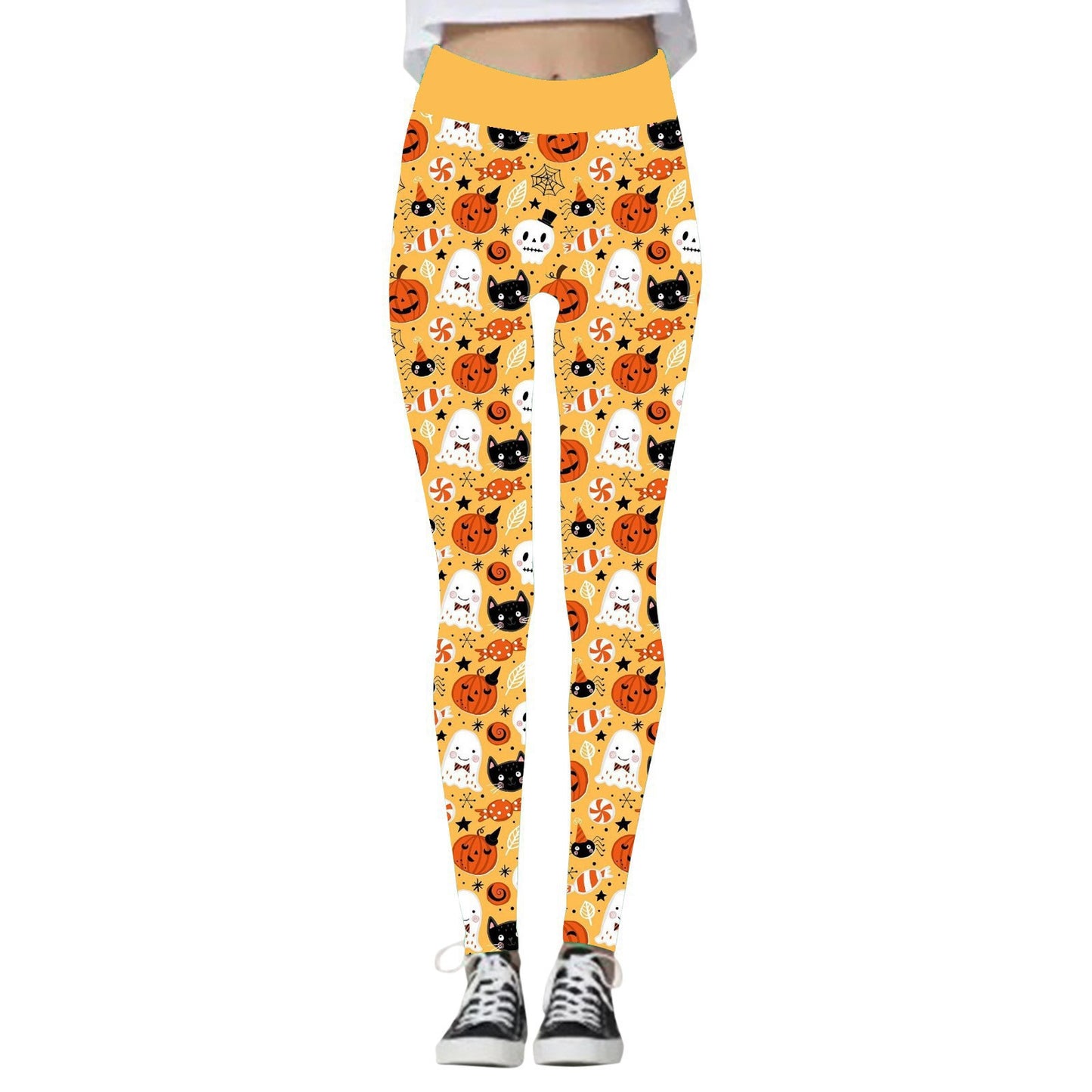 Orange leggings with Halloween-themed print including ghosts, black cats, pumpkins, and candy. Worn with black and white sneakers, featuring a waistband and fitted design.