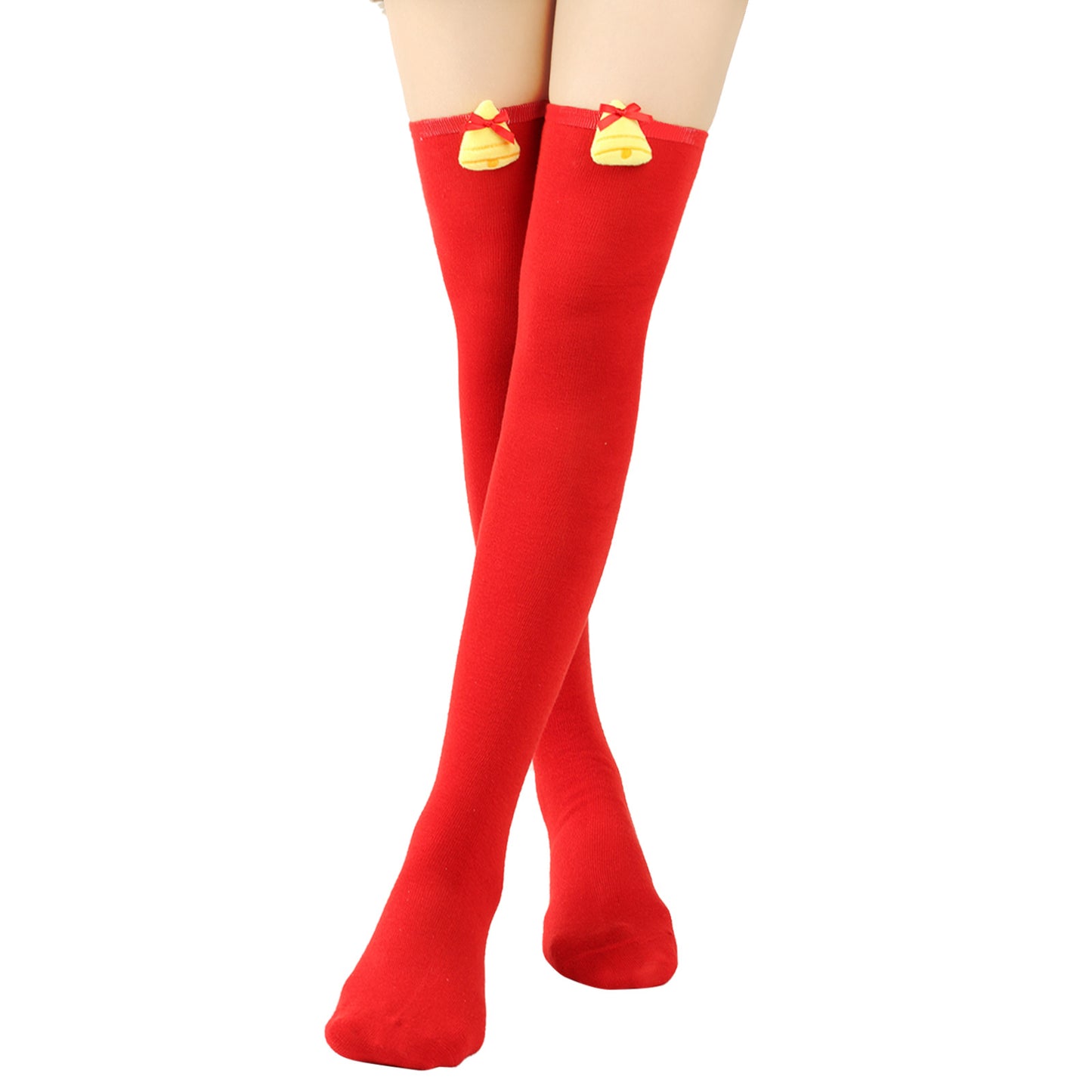 Red knee-high socks with small yellow bell decorations near the top, worn on crossed legs against a plain white background.