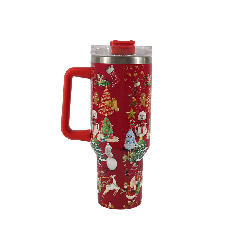 Red Christmas-themed travel mug with a handle, featuring festive designs like snowmen, Santa, reindeer, and Christmas trees. Clear lid with red slider lid.