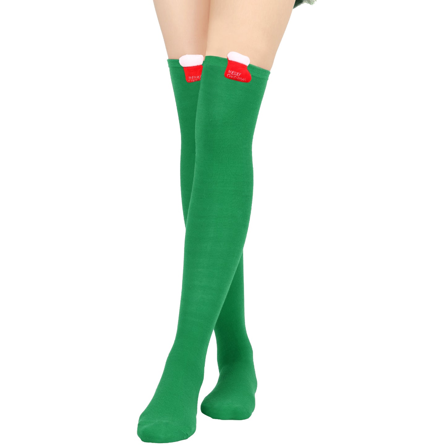 Person wearing green knee-high socks with attached red and white Christmas stocking decorations at the top. "Merry Christmas" is visible on the stockings.