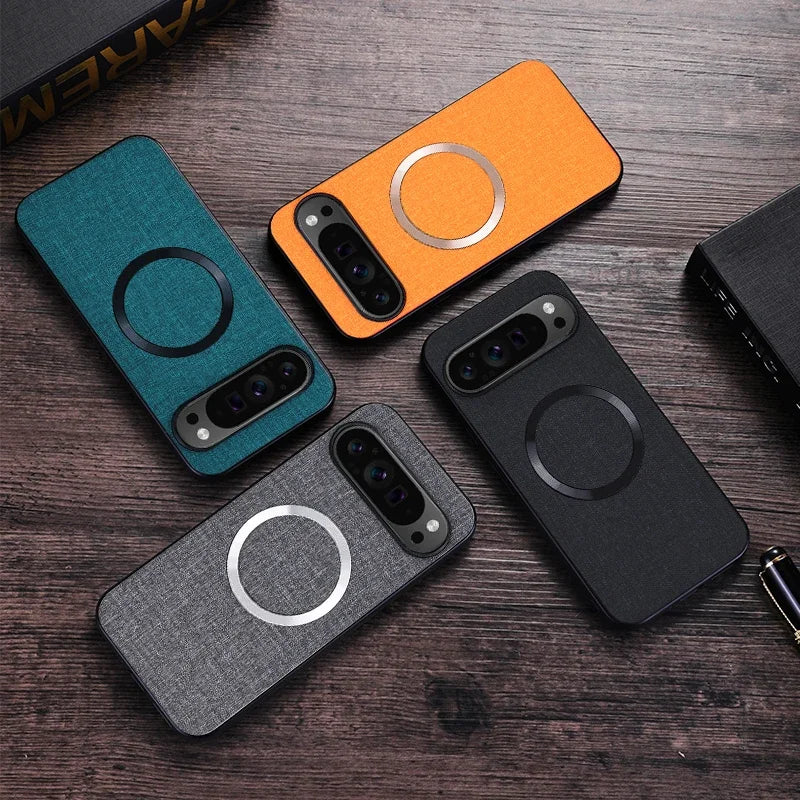 Four smartphone cases with circular designs in teal, orange, gray, and black are arranged on a wooden surface.