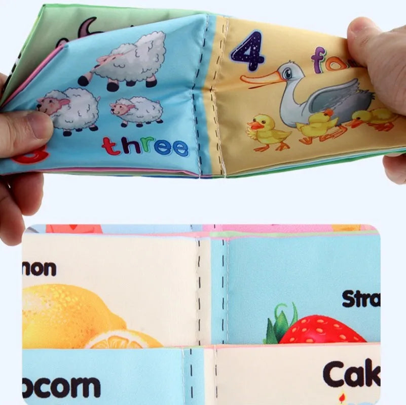 Hands holding a colorful fabric book for children, showing pages with illustrations of sheep labeled "three" and ducks labeled "four." Bottom section displays more bright images.