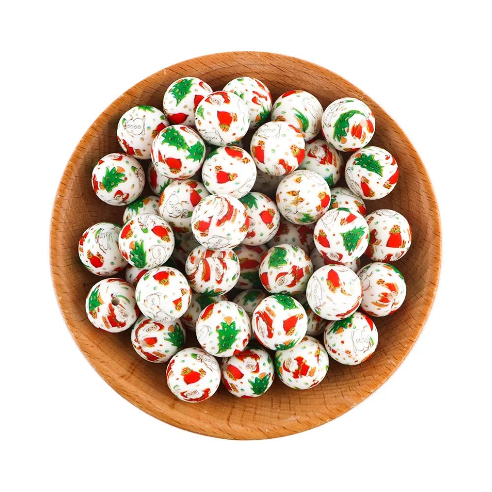 Wooden bowl filled with white beads featuring colorful Christmas-themed designs, including Santas, Christmas trees, and stockings, on a plain white background.