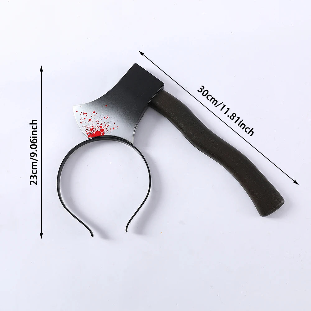 Plastic headband with a fake axe, appearing blood-stained, measures 30 cm by 23 cm. The handle is dark brown; axe blade is gray with red splatters.