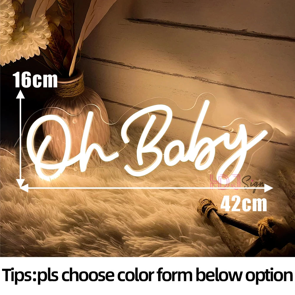 Neon sign reading "Oh Baby" in warm light, measuring 16cm by 42cm, against a cozy background with a vase and decorative plants. Text below: "Tips: pls choose color form below option."
