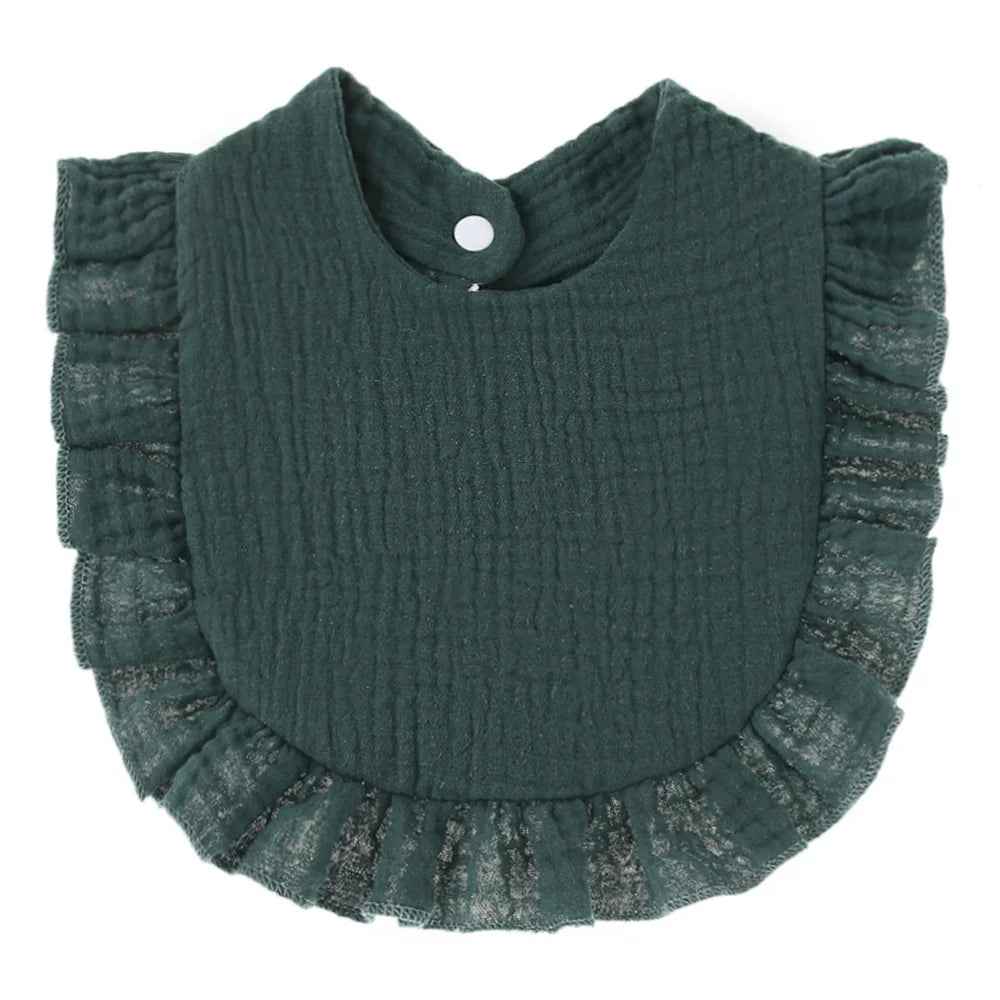 Dark green ruffled baby bib with a textured fabric and lace trim. It features a snap closure at the back for easy fastening.