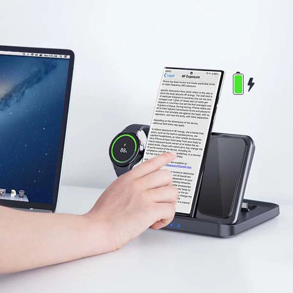 A person operates a smartphone on a wireless charging station, next to a smartwatch. The smartwatch displays 88% charge. A laptop screen is visible on the left side.