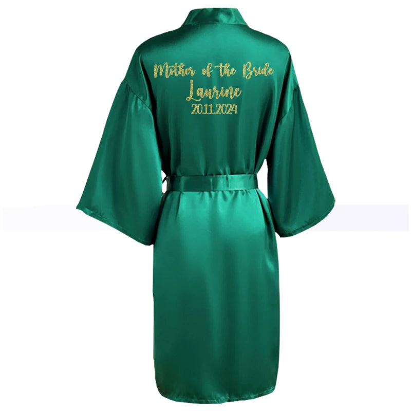Green satin robe with gold text on the back reading "Mother of the Bride, Laurine, 2011-2024." The robe features wide sleeves and a waist tie.
