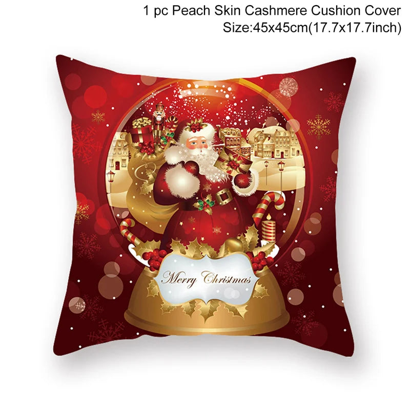 Red Christmas-themed cushion cover featuring Santa carrying gifts, set against a snowy village backdrop. Text reads "Merry Christmas" with festive decorations. Size: 45x45cm.