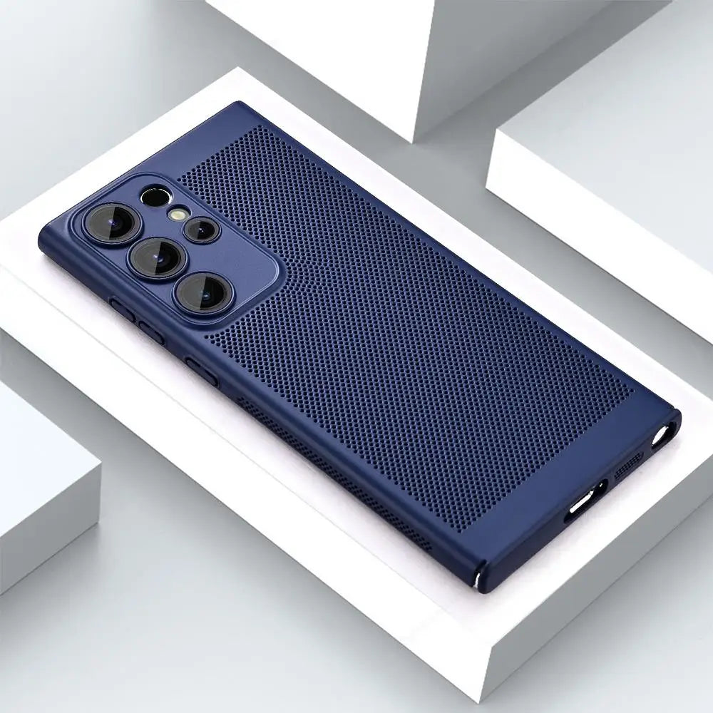 Dark blue phone case with textured grip, featuring three large camera lenses and buttons on the side. The case rests on white and gray geometric surfaces.