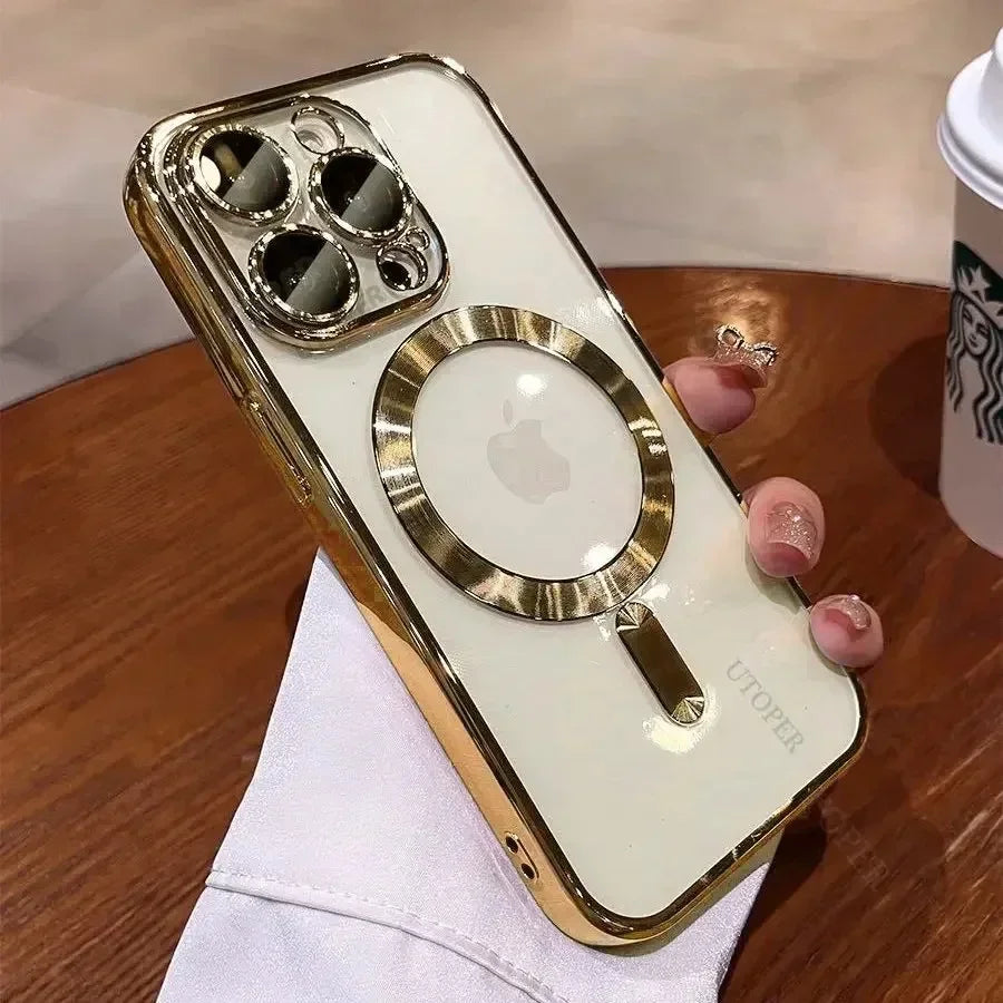 A hand holding a smartphone with an elegant white and gold case, featuring a large circular design and prominent camera lenses. A coffee cup is visible in the background.