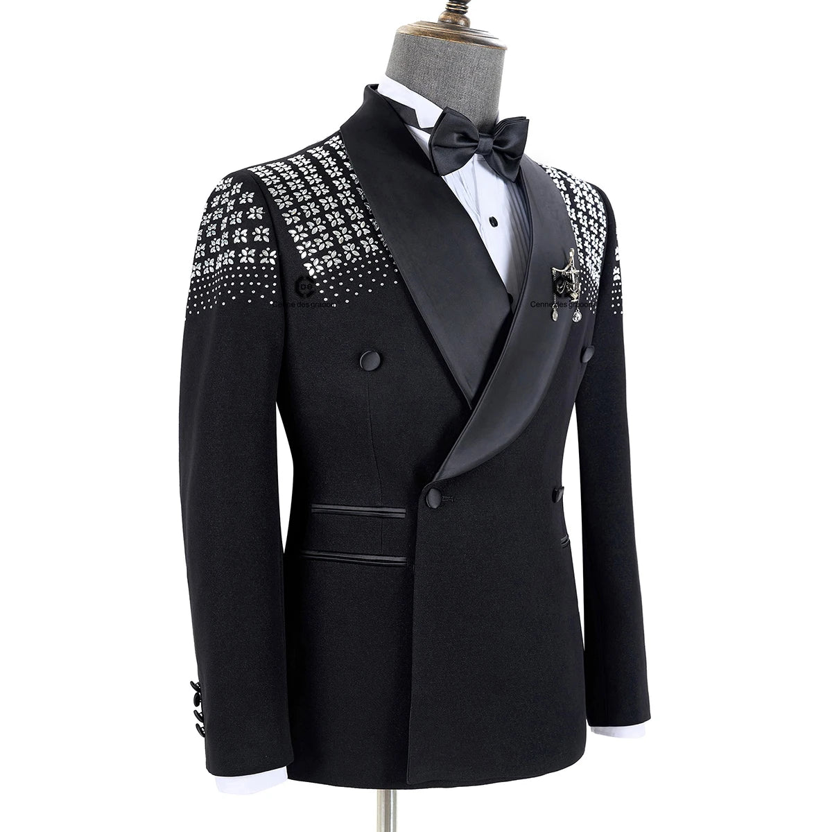 Elegant black tuxedo with rhinestone-embellished shoulders, satin peak lapels, double-breasted design, white shirt, and black bow tie.