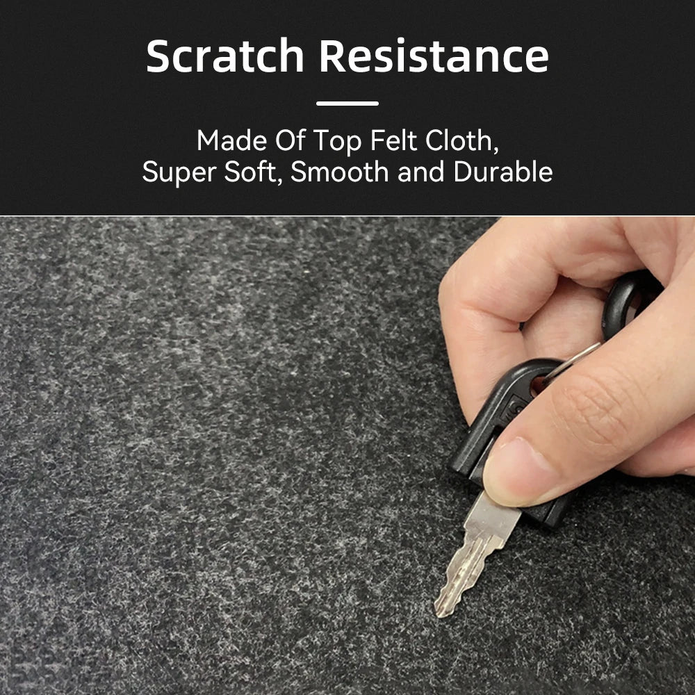 A hand holds a key scratching a textured, black felt cloth surface, showcasing its scratch resistance. Text above reads "Scratch Resistance: Made of Top Felt Cloth, Super Soft, Smooth and Durable."