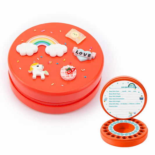 Red circular tooth storage box with unicorn, rainbow, and love decorations on the lid. The open lid reveals baby information fields and 28 compartments for baby teeth.