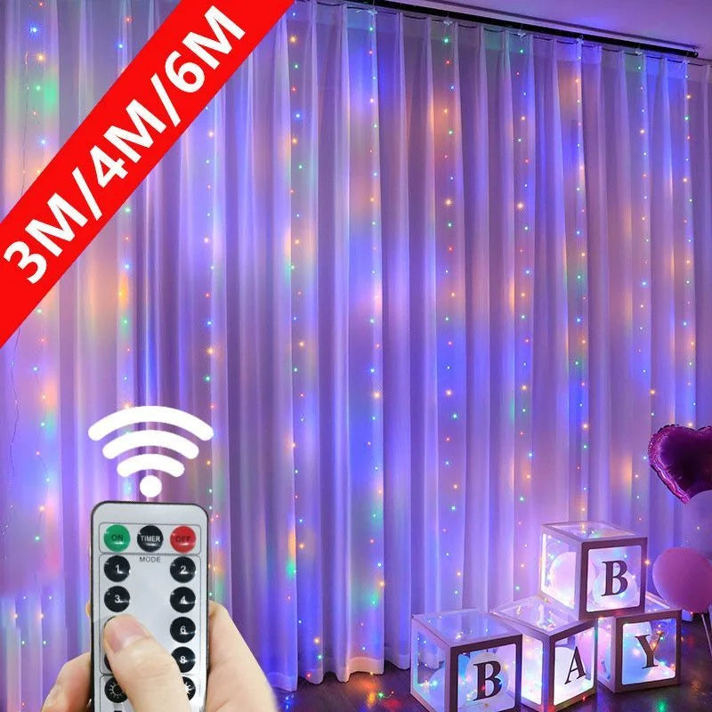 Colorful LED curtain lights with a remote control are hung over white drapes. Below, light-up blocks spell "BABY." A purple balloon is partially visible on the right.