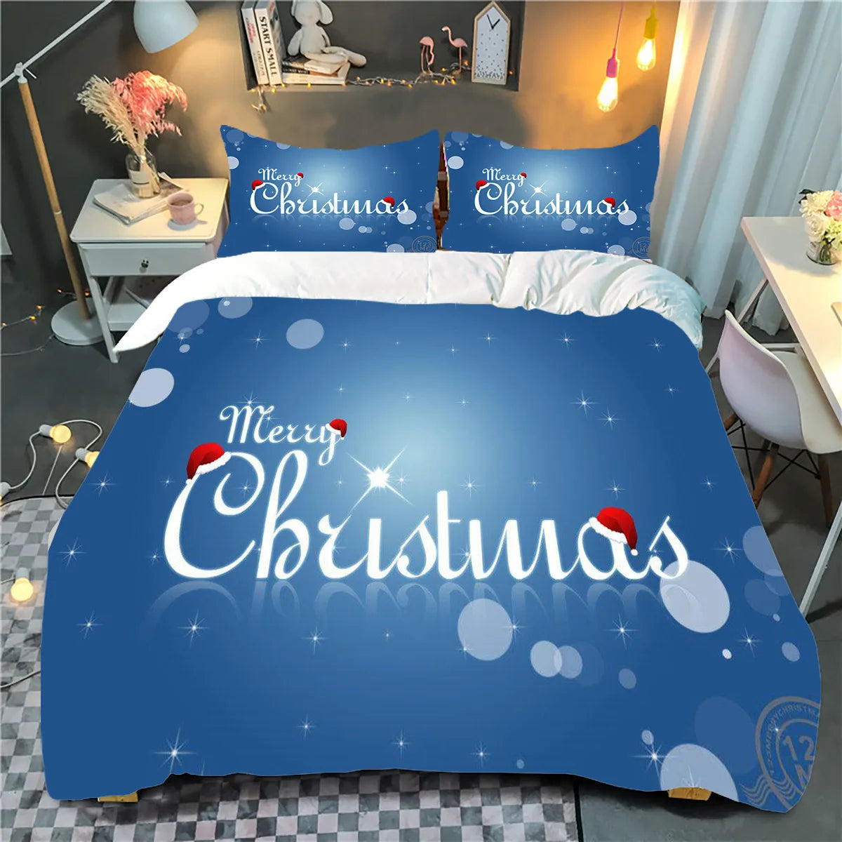 Cozy bedroom with blue "Merry Christmas" themed bedding, featuring snowflakes and Santa hats. Soft lighting and decor create a festive, warm atmosphere.