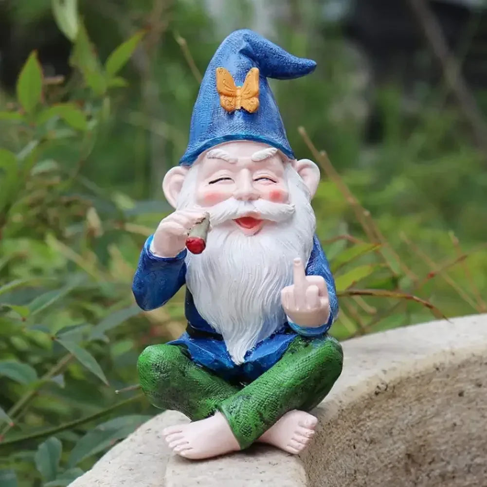 Cheerful garden gnome with a bushy white beard, wearing a blue hat with a yellow butterfly, sits cross-legged on stone ledge, holding a cigar and making a rude gesture.