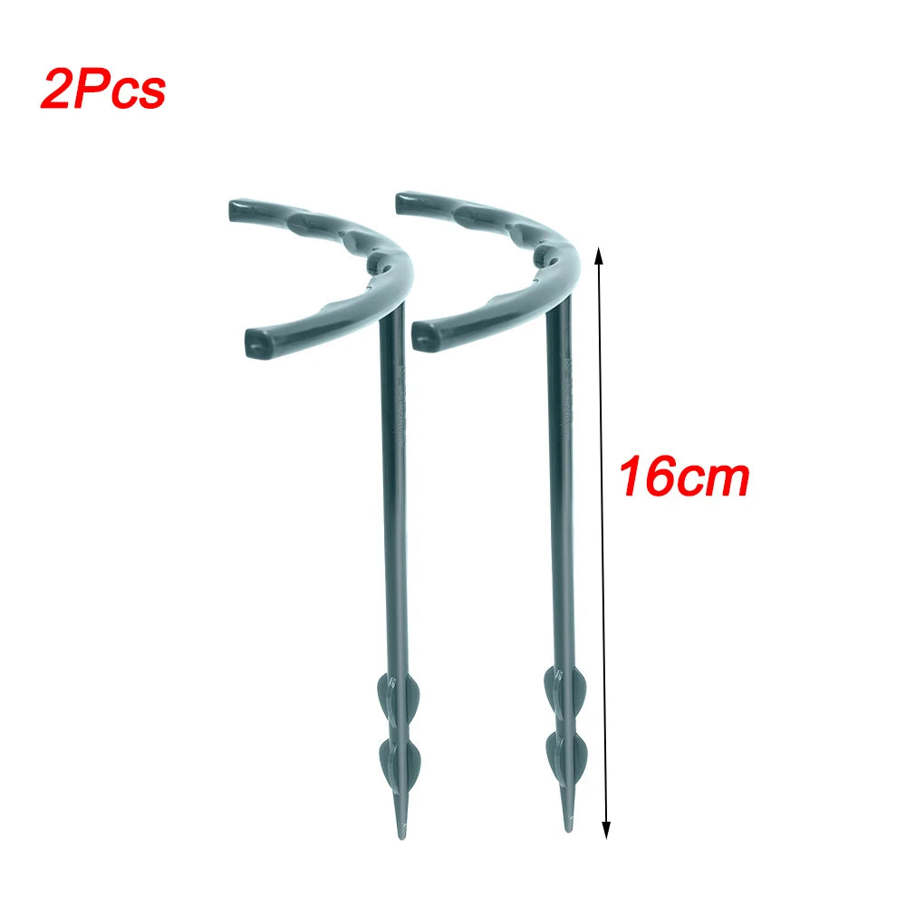 Two gray plastic ground stakes, each with a curved top and pointed end, measuring 16 cm in length. Red text indicates "2 Pcs" and the dimension.