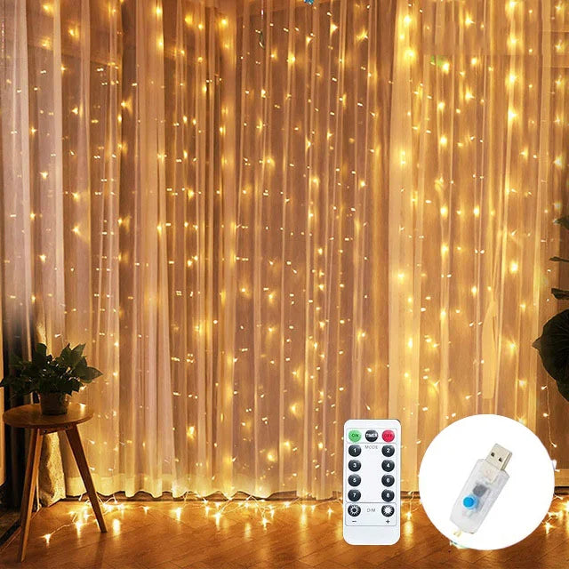 Warm fairy lights hang in front of sheer white curtains, creating a cozy ambiance. A small round table with a plant sits to the left. A remote control and USB adapter are shown.